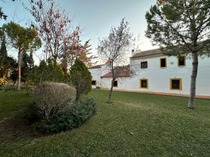 BobadillaXPCE Casería San José的院子里有树木的白色房子