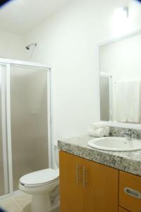 莫雷洛斯港Edifico con departamentos amplios cerca de la playa的浴室配有卫生间、盥洗盆和淋浴。