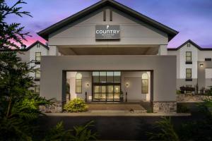 格兰维尔Country Inn & Suites by Radisson, Grandville-Grand Rapids West, MI的上面有社区标志的建筑