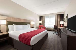 德卢斯德卢斯北江山酒店的酒店客房配有一张床、一张书桌和一台电视。