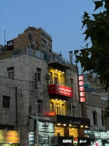 安曼Roman Theater Hotel的建筑的侧面有 ⁇ 虹灯标志