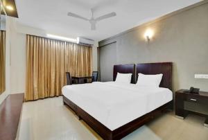 阿勒皮AEC Travel and Leisure Solution Pvt Ltd的卧室设有一张白色大床和一扇窗户。