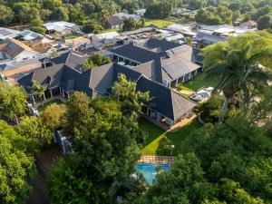 格罗布勒斯达尔Familia Guesthouse的享有带游泳池和树木的房屋的空中景致
