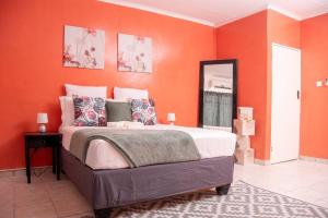 马翁Laha Apartment 3的一间卧室拥有橙色的墙壁和一张大床