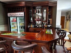 JwanengMeyers Guesthouse的酒吧设有一张大木桌和椅子