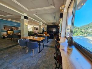 乌来乌来水岸温泉馆的餐厅设有桌椅和大窗户。