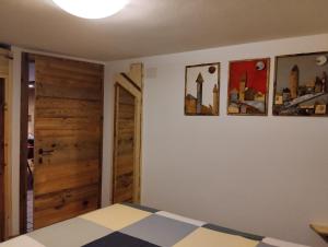 坎皮泰洛迪法萨Botton d'oro的卧室配有一张床,墙上挂有两张照片