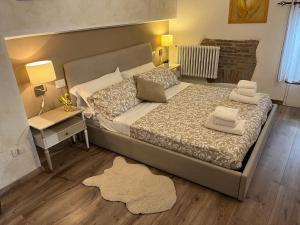维泰博DOMUS TUSCIA APARTMENTS San Faustino guesthouse的一间卧室配有一张大床、床头柜和一张桌子