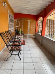 马瑙斯Casa Edgar的走廊上一排椅子,有橙色的墙壁