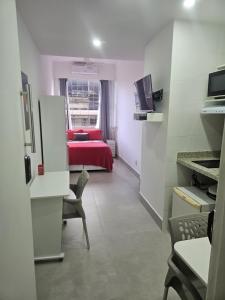 里约热内卢Studio Reformado coração Leblon的一间设有红色床的房间和一间带窗户的房间