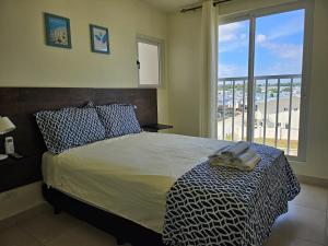 ArraijÃ¡nVista al mar 303的一间卧室配有一张床,享有海滩美景