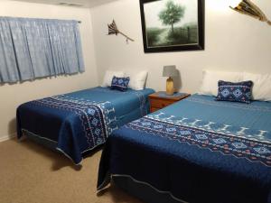 布拉夫莫奇汽车旅馆的配有蓝色棉被的客房内的两张床