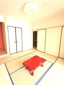 堺市知輪-chirin-的一间铺有红色地毯的客房