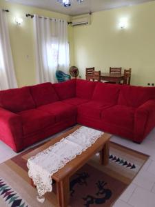 克里比Residence Mindja的客厅里一张红色的沙发,配有茶几