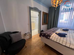 于斯德Pension Marie Luise 251 - Zimmer Herzmuschel的卧室配有床、椅子和窗户。
