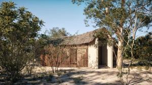 维勒珀图Taru Villas Villu - Wilpattu的沙漠中一座茅草屋顶的小建筑