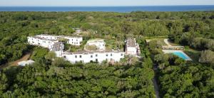 奥特朗托塞拉德利阿里米尼3号牵牛星公寓式酒店的树林中白色大房子的空中景色