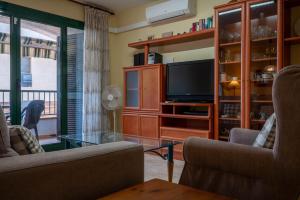 托里代巴拉AT044 Els Porxos的客厅配有两把椅子和电视