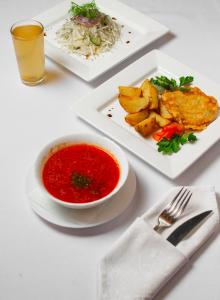 LokhvytsyaГотель Україна的一张桌子,上面放着两盘食物和一碗汤