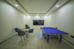 蒂鲁帕蒂Lake Valley Resort and Spa Tirupati的一个带椅子的房间里一张乒乓球桌