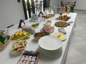 加利波利MACHIAVELLI HOUSE的一张带盘子和食物的白色桌子