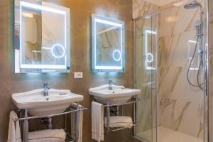 费拉约港奥托尼别墅酒店的一间带两个盥洗盆和淋浴的浴室