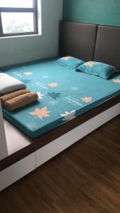 下龙湾Private homestay sea view in Halong center的一张带鲜花的蓝色棉被的床