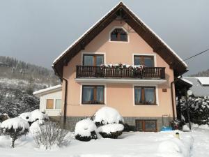 哈沃福卡Domček u Vojta的雪中带阳台的房子