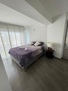 亚美尼亚APTO EN NORTE DE ARMENIA的一间卧室配有一张带紫色棉被的床
