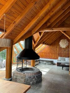 拉安戈斯图拉镇Punta Manzano的带壁炉的客厅设有木制天花板