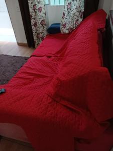 蒙加瓜Casa Praia Mongaguá的红色的床和红色的棉被