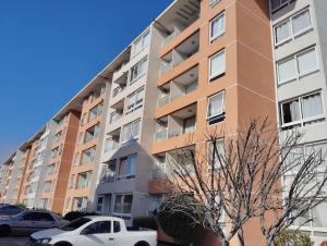 拉塞雷纳Departamente 2 habitaciones 2 baños a pasos playas supermercado y plaza de armas的公寓大楼前面设有停车位。