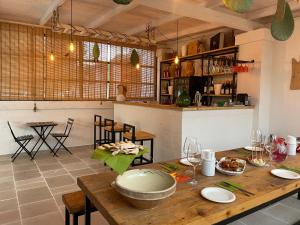 奥斯图尼Tenuta Amostuni-Country House的厨房以及带木桌的用餐室。