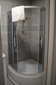 斯文托伊Floros simfonija Jūros的浴室里设有玻璃门淋浴
