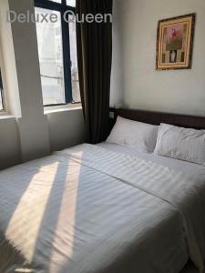 太平Hotel Vistana Micassa的一间卧室设有一张大床和窗户