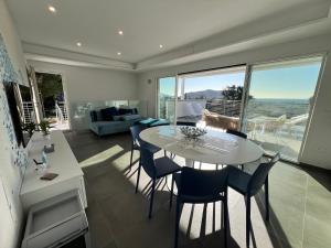 拉科纳Villa Serena vista mare的客厅配有白色的桌子和椅子