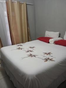 马翁Partulaka Rest Inn的卧室配有带鲜花的白色床
