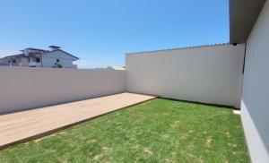 阿罗约多萨尔Casa Mar Dom Pedro的后院有白色的栅栏和草地