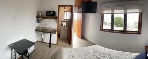 洛斯比洛斯MARITIMO SUITE的一间卧室配有床、水槽和窗户