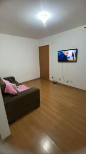 孔塔任Apartamento Super Aconchegante em Ambiente Familiar的客厅配有床和平面电视
