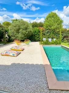 圣萨蒂南艾普特villa Luberon的游泳池旁设有两把草坪椅