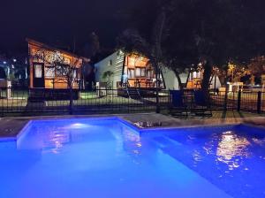 科隆Cabañas Posta Litoral的夜间在房子前面的游泳池