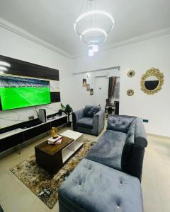 哈科特港Owtee’s Apartments的带沙发和平面电视的客厅
