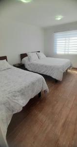 Hostal Tabancura客房内的一张或多张床位