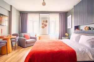 伊斯坦布尔TAKS-INN Suites的一间卧室配有一张床、一把椅子和一张桌子