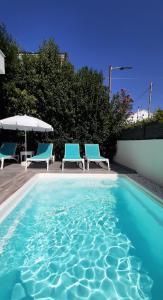 卡西奥皮The Central Villa - Kassiopi Corfu Villas的一个带两把椅子和遮阳伞的游泳池