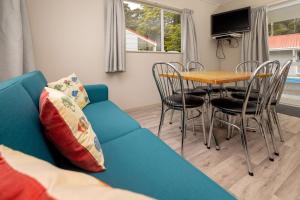 奥阿库尼奥阿库尼前10名假日公园酒店的客厅配有蓝色的沙发和桌子