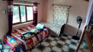 博卡拉HIMALAYAN AAMA APARTMENT的一间小卧室,配有床和窗户