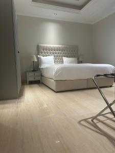 利雅德GAZLA的白色卧室设有一张大床和一盏灯。