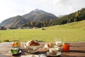 阿亨基希Das Ferienhaus in Achenkirch的一张带碗食物的木桌,享有田野的景色